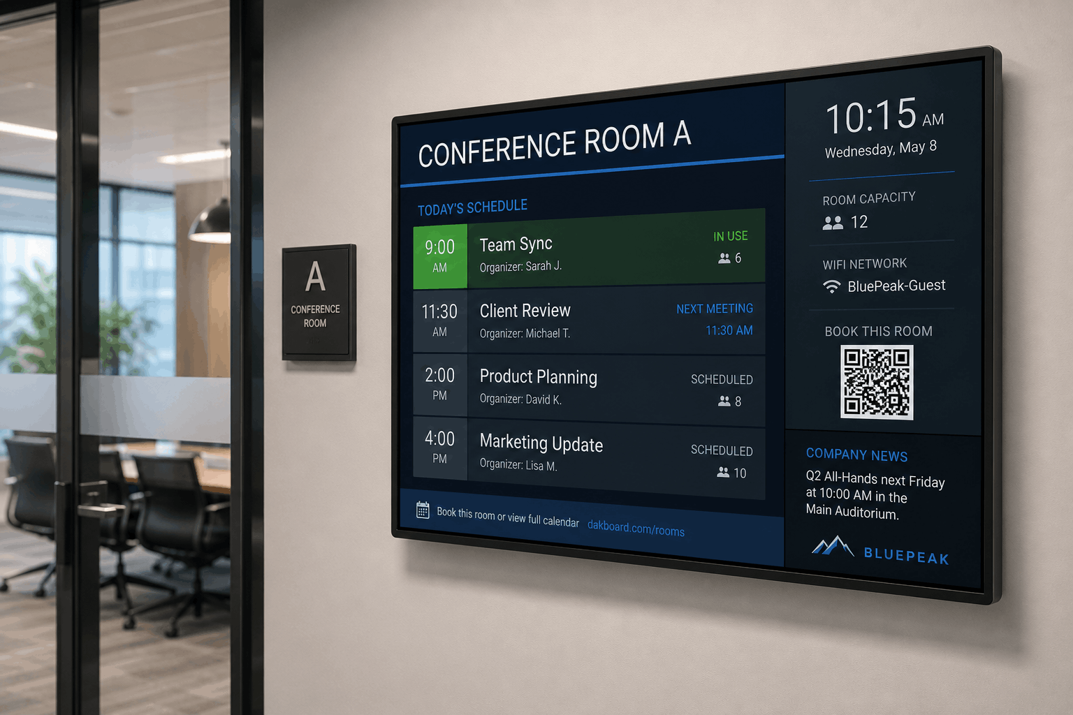 Wall-mounted DAKboard conference room display showing today's meeting schedule, capacity, and a QR code to book the room