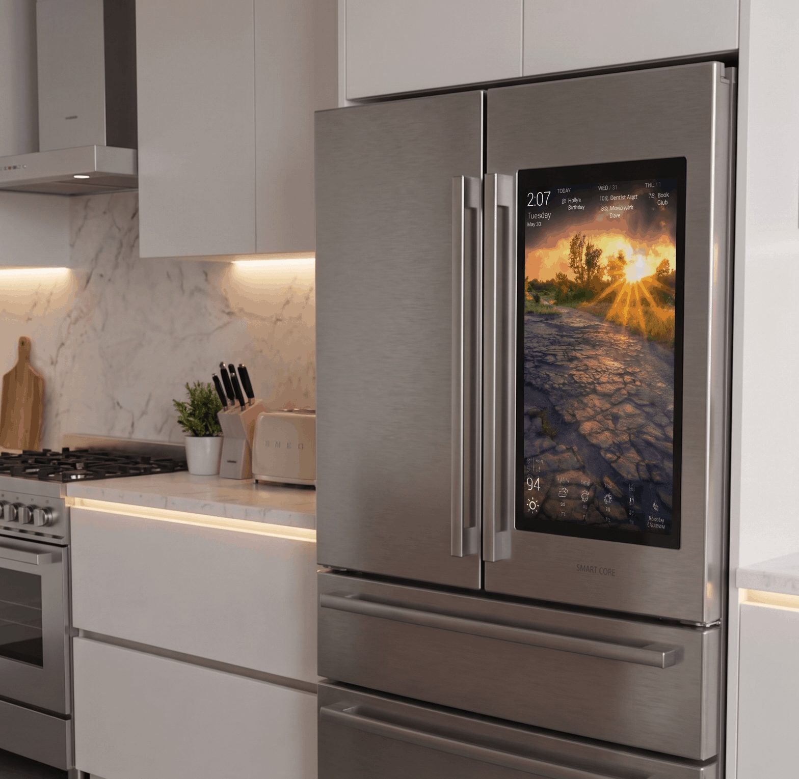 DAKboard on a smart fridge DAKboard running on a smart refrigerator's built-in touchscreen in a modern kitchen, showing the day's agenda, upcoming events, and a weather forecast