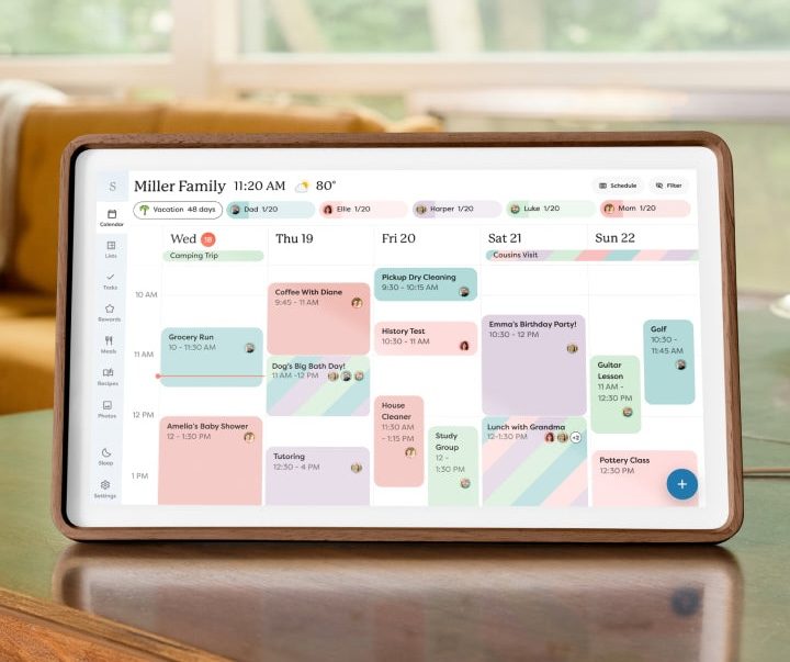 Skylight Calendar touchscreen mounted on a kitchen wall showing a color-coded family schedule