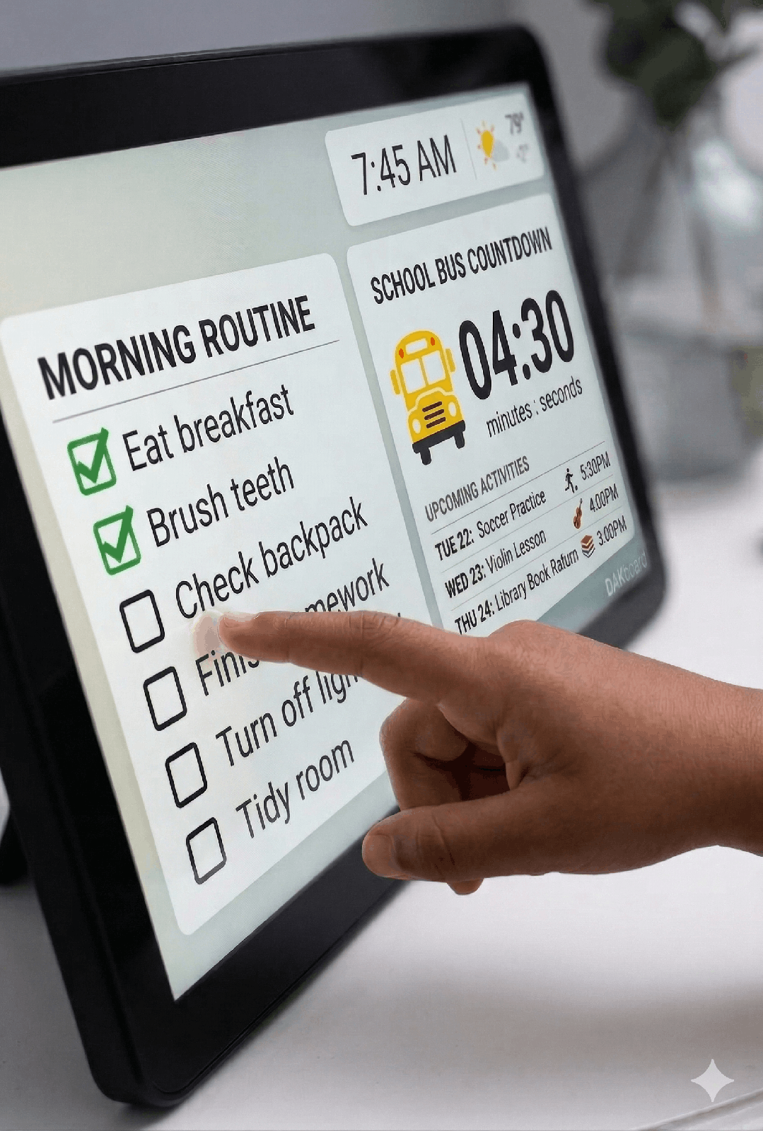Child tapping a touchscreen DAKboard checklist of morning routine chores with a school bus countdown timer for kids
